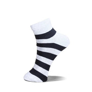 A single ankle sock with horizontal black and white stripes, shown floating against a solid white background.