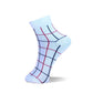 A single ankle sock with a white base and a grid pattern in navy blue and red, shown on a clean white background.