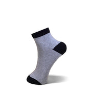 A single ankle sock shown on a white background, featuring a heather gray ribbed body with black trim at the cuff, heel, and toe.