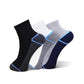 Three pairs of low-cut athletic socks arranged in a fan shape on a white background. The set includes black, white, and heather gray pairs, each with a contrasting light blue toe and cuff stripe.