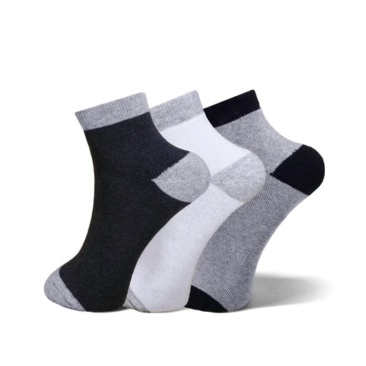 Three pairs of ankle socks in a three-pack, featuring a color-blocked pattern of black, white, and heather gray. The socks are arranged in a fan shape against a clean white background.